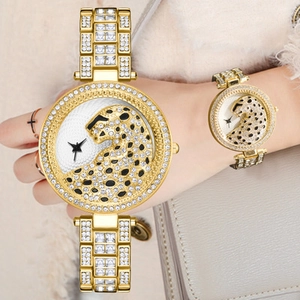 Luxury gold women's watch with crystal leopard head dial and iced out steel band