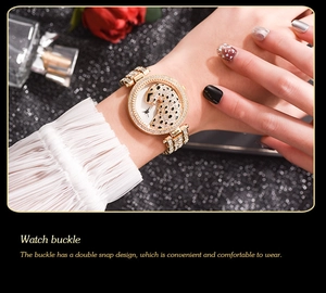 Detail of luxury gold women's watch with double snap buckle and rhinestone leopard dial