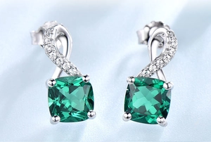 Detailed macro view of S925 sterling silver drop earrings with emerald square gemstones