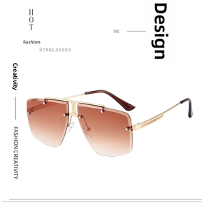 Detail view of oversized rimless gradient brown sunglasses with gold metal temples and rivets