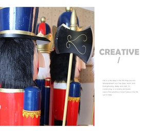 Macro detail of wooden nutcracker soldier with red blue finish and golden ax accessory