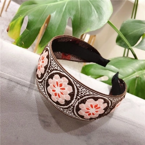 Ethnic style embroidered knot headband with floral patterns on coffee fabric