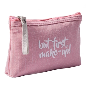 Pink canvas makeup bag with zipper and But first, make-up! text on white background