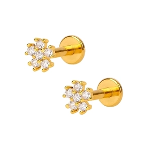 Minimalist gold flower stud earrings with sparkling white zircons on a white background