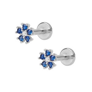 Macro detail of silver snowflake stud earring with navy blue and clear zircon crystals