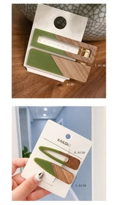 Detail of forest green and wood grain hair clips in rectangular and drop shapes