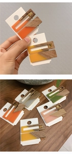 Close-up of candy-colored acrylic and wood rectangular hair clips in various bright shades