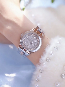 Detail shot of luxury women's silver quartz watch with full crystal pavé dial and bezel