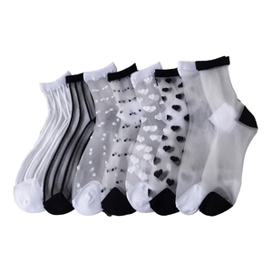 Set of 7 sheer mesh women socks with cute polka dots and heart patterns on white background