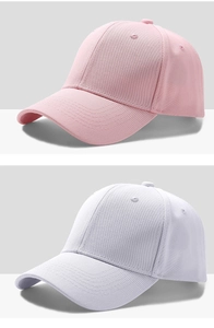 Detail of pink and white baseball caps in twill cotton with reinforced stitching