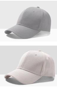 Detail view of twill fabric and embroidery eyelets on grey and beige baseball caps