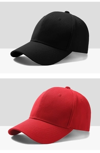Detail of classic black and red cotton baseball caps showing 6-panel structure and curved brim