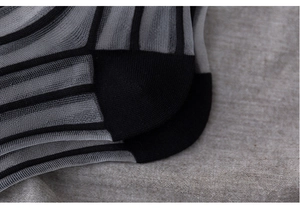 Macro shot of breathable mesh texture and reinforced heel on striped cotton socks
