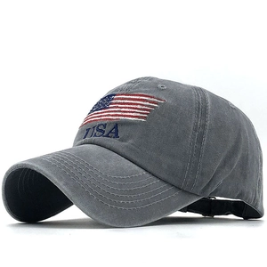 Washed grey cotton baseball cap with USA embroidery and American flag on a plain background