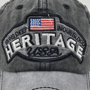 Detailed embroidery of Heritage USA logo and American flag on vintage distressed cap