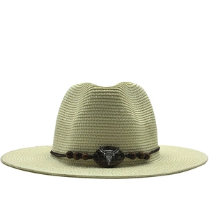 Beige western straw hat with wide brim and bull head emblem for beach sun protection