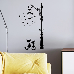 Detail of couple cats and lamppost wall sticker on grey wall with yellow sofa