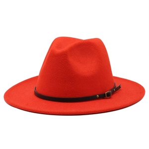 Detail of red wool fedora hat featuring a black leather band and vintage gold metal buckle