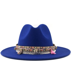 Detail of royal blue wool fedora featuring ethnic woven bands and seashell charms
