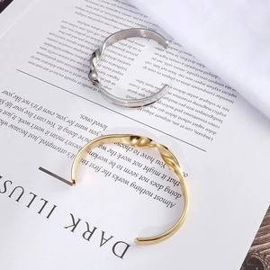 Minimalist Mobius twist open cuff bracelets in polished gold and silver finishes