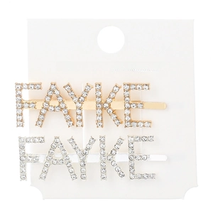 Macro shot of gold and silver plated metal hair clips with FAYKE rhinestone letters
