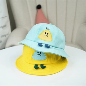 Detail of mint green and lemon yellow children's sun hats with cartoon embroidery