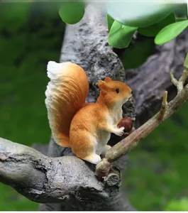 Detail of a resin squirrel figurine holding a nut for succulent micro landscapes