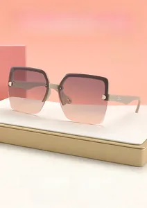 Detailed close-up of nude frame sunglasses featuring a metal D logo and gradient lenses