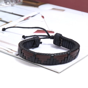 Macro detail of braided leather bracelets with adjustable black cord and woven textures