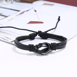 Detail view of a black braided leather bracelet featuring a central knot and dual layers