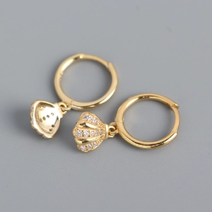 Macro detail of gold-plated S925 silver shell earrings featuring micro-pave zirconia stones
