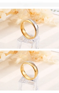 Detail view of two-tone titanium steel couple rings with polished finish and pavé diamonds