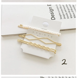 Detailed view of 3-piece elegant pearl hair clips set on a stylish display card