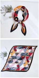 Detailed view of pleated silk scarf featuring colorful geometric patterns and silky texture