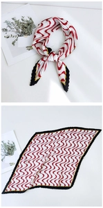 Detail of pleated square silk scarf with red white wave pattern and scalloped edges