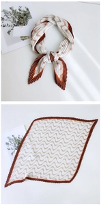Macro view of pleated square scarf with brown wavy patterns and textured finish
