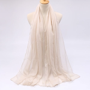 Close-up of lightweight breathable cream chiffon fabric texture on a long sun shawl