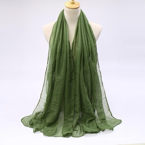 Detailed view of olive green voile scarf showing natural texture and soft fabric wrinkles
