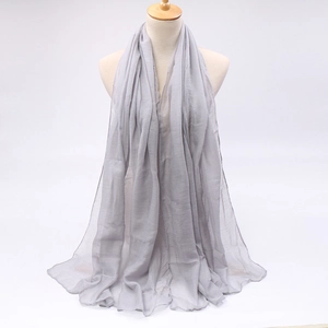 Macro shot of light gray long scarf with lightweight breathable texture on a white mannequin