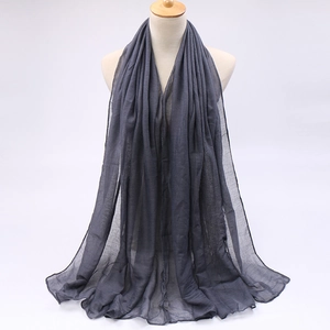 Detail of dark grey voile scarf showing lightweight translucent fabric and soft texture