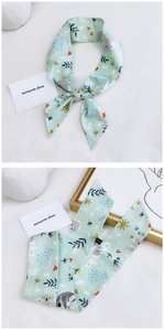 Macro detail of 100% cotton light green scarf featuring cute koala and botanical prints