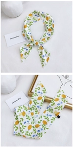 Detail showing elegant long cotton linen scarf with vibrant lemon and leaf floral prints