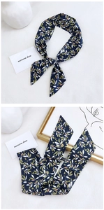Detail showing the 100% cotton material and navy blue leaf print of this fashion scarf