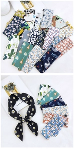 Detailed view of various floral and patterned cotton linen scarves for hair and wrist styling