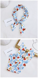 Detail view of cotton-linen twilly scarf with blue leaves and berry pattern print