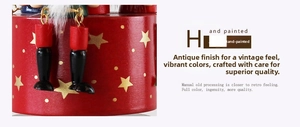 Detail of hand-painted wooden nutcracker music box with gold metal rings and boots
