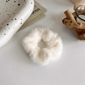 Dettaglio dell'elastico in morbido peluche bianco su un vassoio decorativo chic