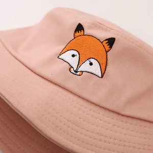 Close-up of a pink cotton bucket hat with a detailed cartoon fox head embroidery
