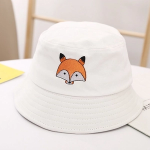 Detailed close-up of cartoon fox embroidery on a white cotton kids bucket sun hat