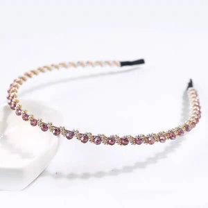 Detail of purple crystal beaded headband with gold accents and soft protective tips